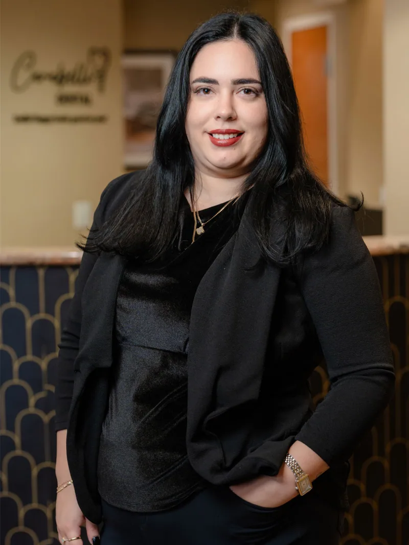 Thalia, office manager at Carabelli Dental, in a professional portrait.