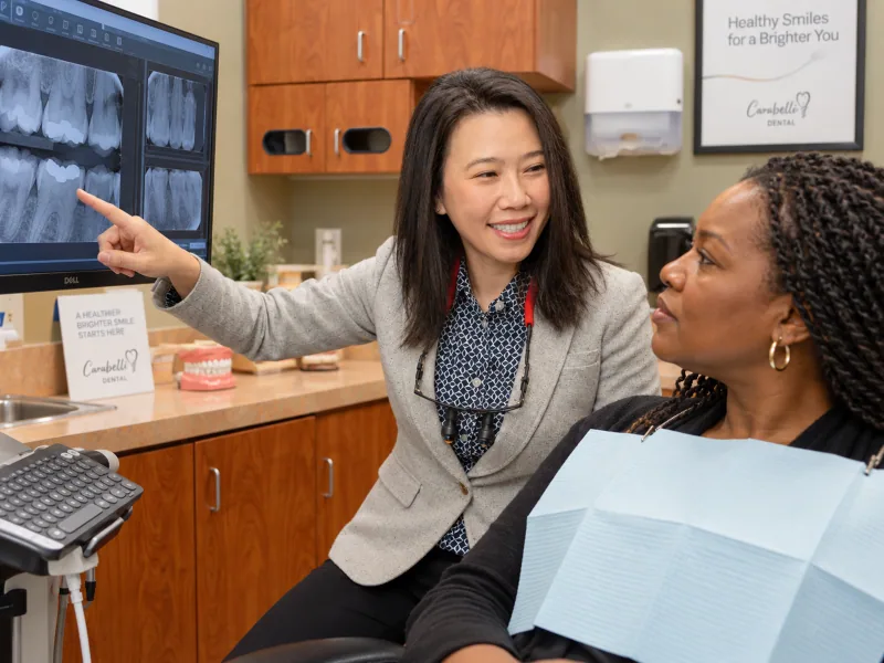 A dentist explaining findings from a focused dental examination to a patient.